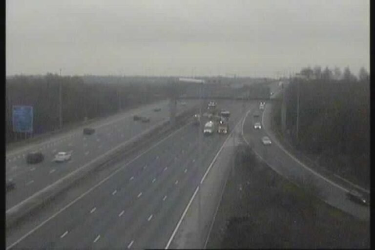 A car being examined by forensic experts at the scene of a fatal incident on the M6 motorway, with a focus on determining the cause of the accident and improving road safety