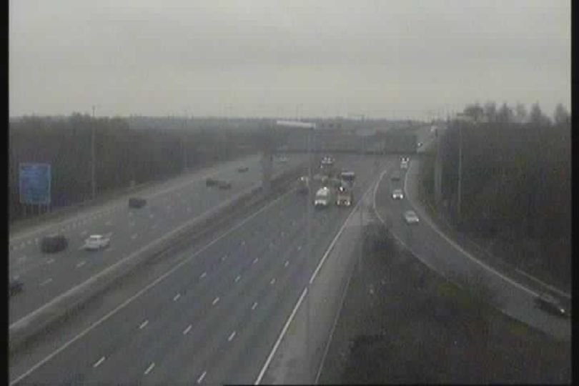 A car being examined by forensic experts at the scene of a fatal incident on the M6 motorway, with a focus on determining the cause of the accident and improving road safety