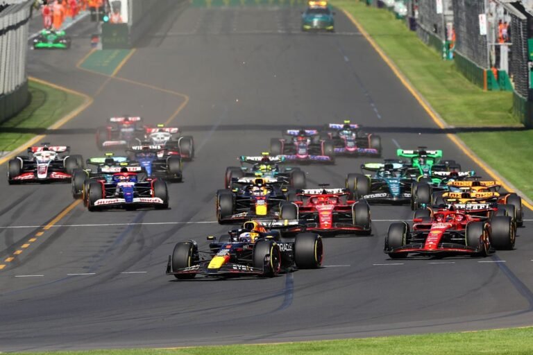 Watch the Australian Grand Prix live with our F1 streaming guide, featuring a photo of a Formula 1 car racing on the Melbourne track, with a crowd of spectators in the background, and a description of the primary keyword F1 live streams