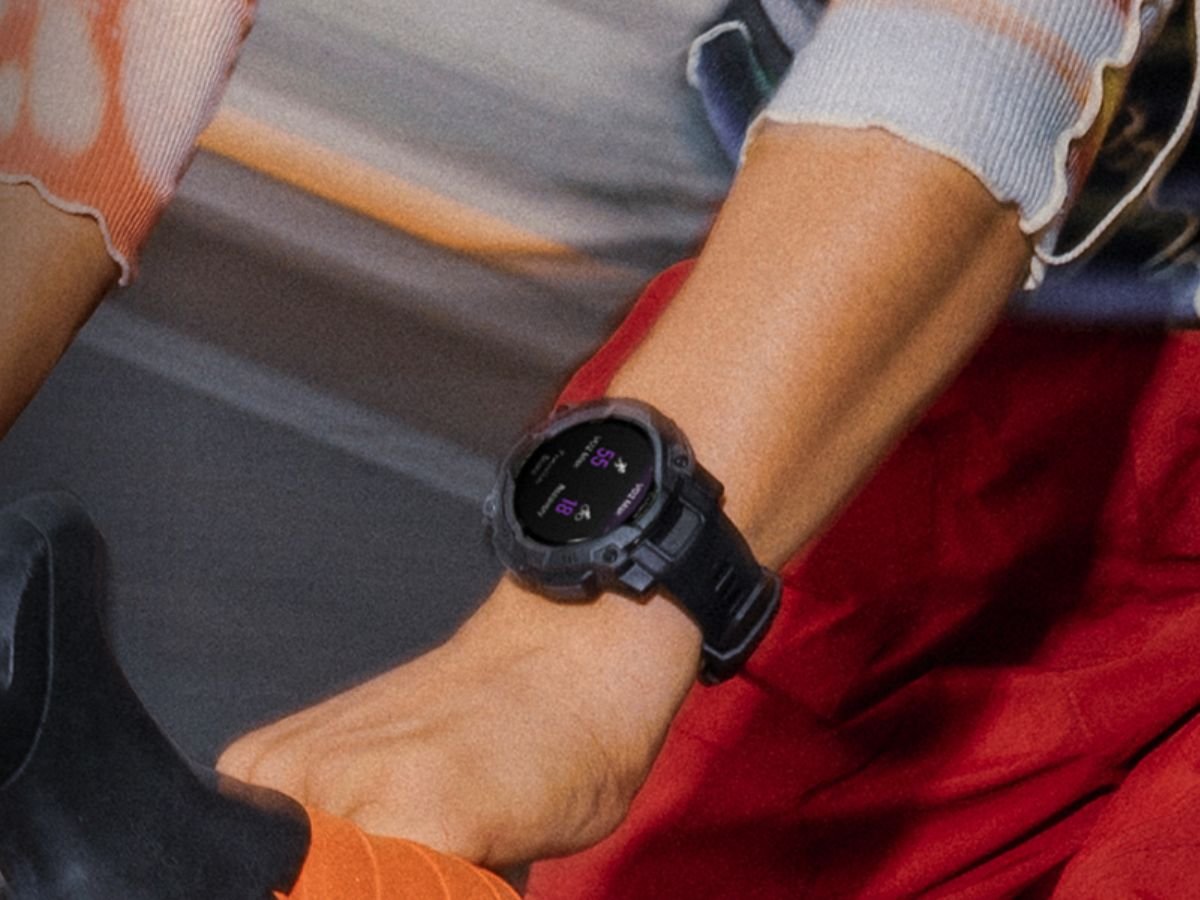 A person wearing a Garmin smartwatch while running in the UK, with a scenic backdrop of the countryside. The smartwatch is displayed on the wrist, showcasing its sleek design and vibrant colour display. The image captures the essence of fitness tracking in the UK, with the Garmin smartwatch at the forefront of the scene.