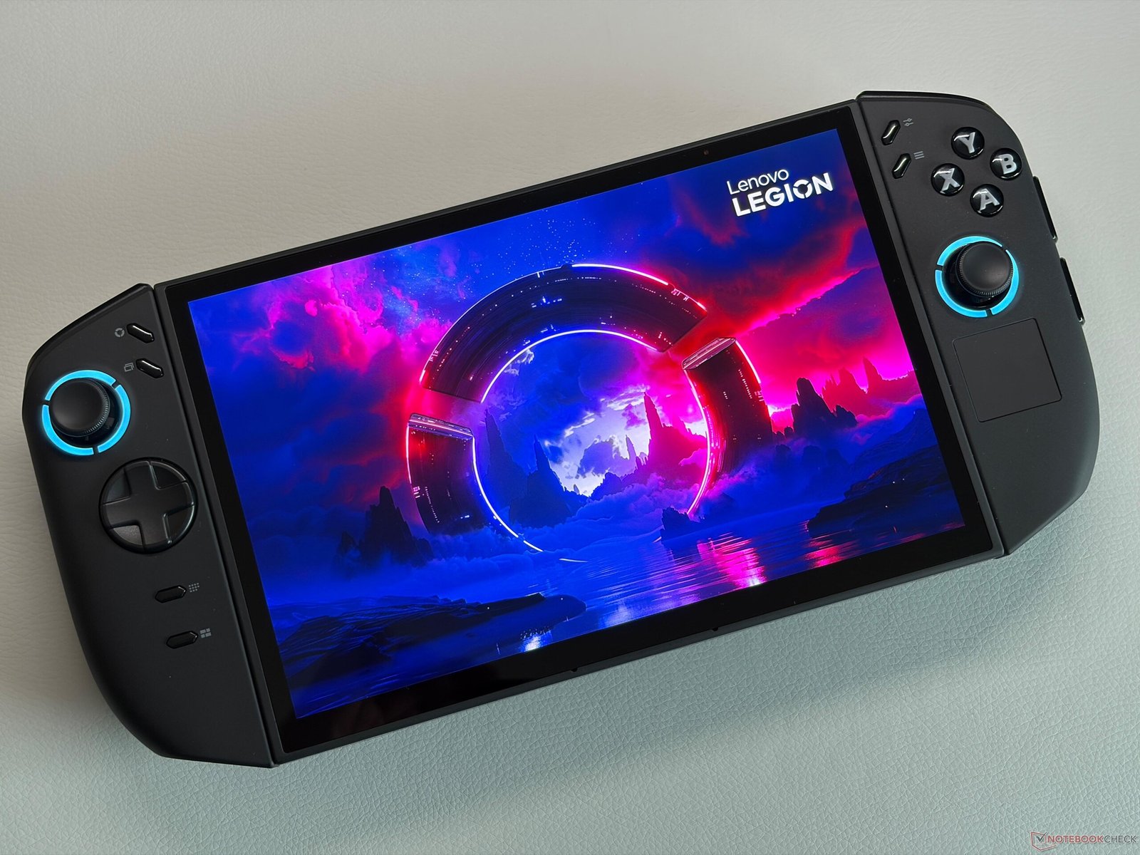 A person holding a Legion Go handheld device, with a stunning Xbox game on the screen, showcasing the Xbox Full Screen Experience in the UK