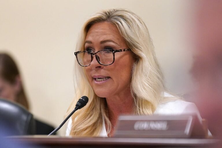 MTG and Karoline Leavitt pictured in a heated exchange, highlighting the intense debate surrounding the Iran war draft and its potential consequences for the US and the global community, with a focus on the behaviour of key players and the colour of politics