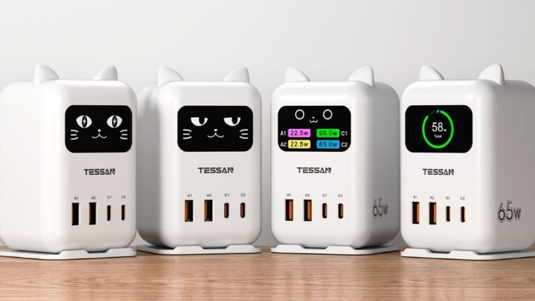 A desktop USB charging station with an animated cat face display, featuring two USB-C and two USB-A ports, surrounded by UK-themed accessories and gadgets, with a colourful and modern design