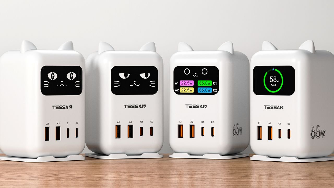 A desktop USB charging station with an animated cat face display, featuring two USB-C and two USB-A ports, surrounded by UK-themed accessories and gadgets, with a colourful and modern design