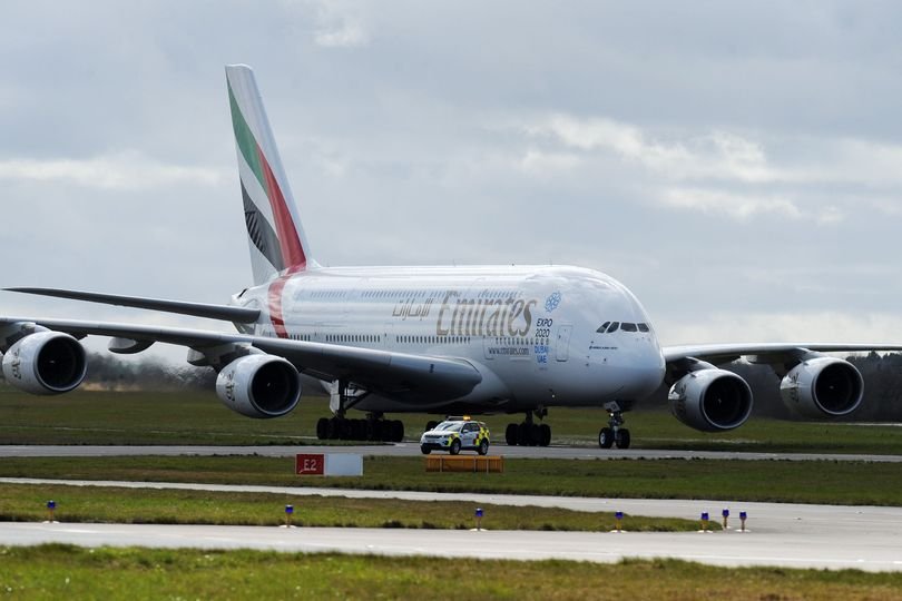 Birmingham Airport terminal building with a plane taking off in the background, with a caption mentioning Emirates flights and Iran conflict