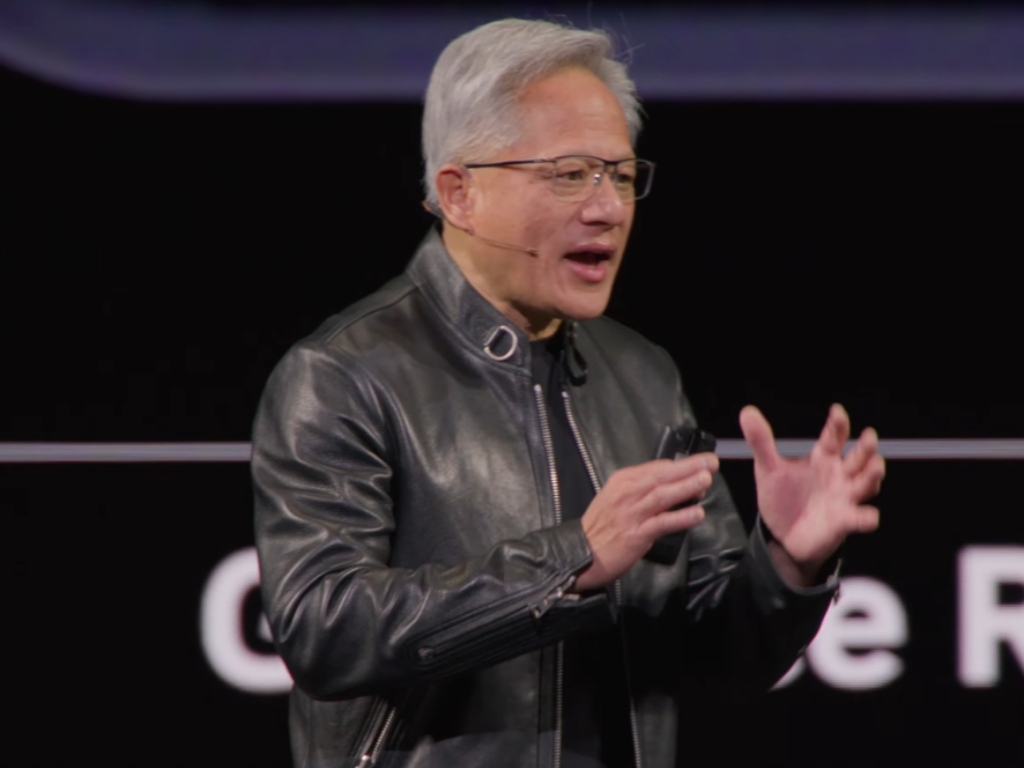 Nvidia CEO Jensen Huang speaking at a conference about DLSS 5 technology, with a focus on its potential to enhance gaming visuals in the UK, using generative AI to improve performance and visual quality
