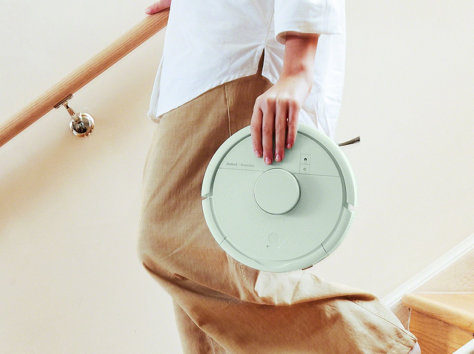 The iRobot Roomba Mini, the world's smallest robot vacuum, with AutoEmpty Dock and LiDAR technology, cleaning a UK home with ease, navigating around furniture and reaching tight spaces with its compact design and advanced navigation system