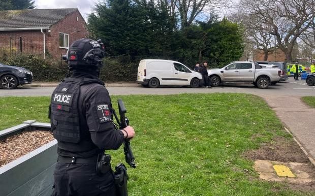 A teenage girl being helped by teachers and students after a stabbing incident at school, highlighting the need for improved security measures and student safety, with a focus on the primary keyword of school stabbing