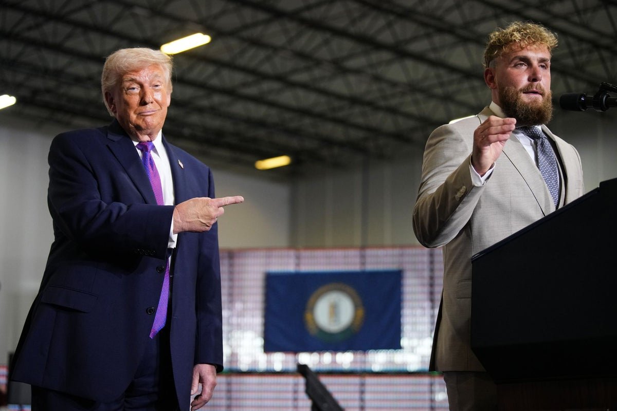 Donald Trump and Jake Paul sharing a YMCA dance, symbolising their unlikely friendship and endorsement, with a crowd of people in the background, highlighting the significant attention their collaboration has received, and the colourful atmosphere of the event