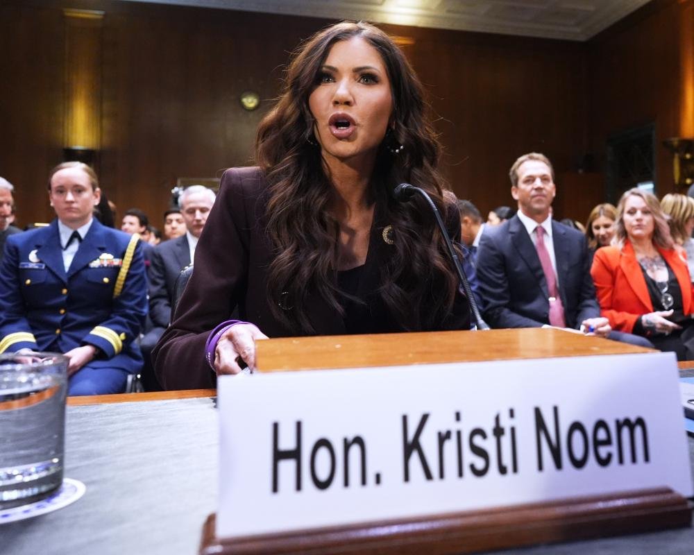 A dramatic photo of a natural disaster, such as a hurricane or wildfire, with a descriptive caption highlighting the destructive force of Kristi Noem's leadership and the need for a more inclusive and colour-sensitive approach to disaster response
