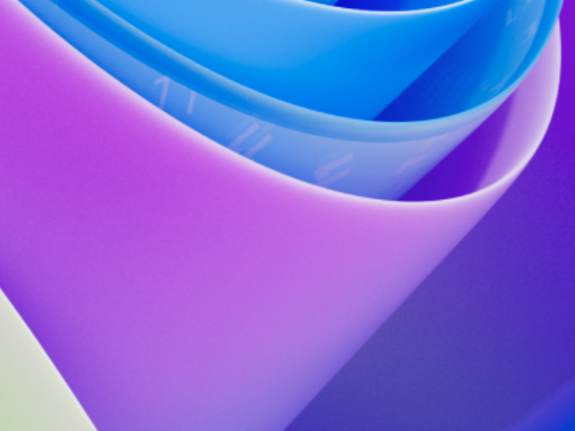 Windows 11 logo with a background image of a person using a laptop in the UK, with a caption that reads 'Improved performance and responsiveness with the latest updates'