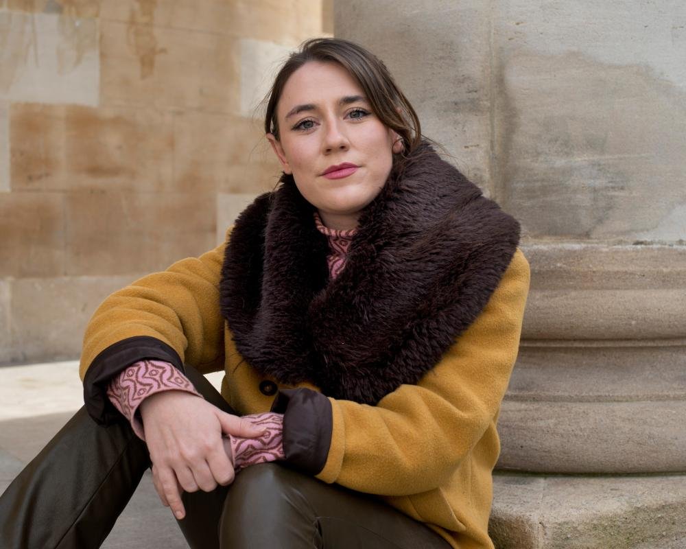 A group of people gathered around a computer, looking at Facebook's logo with a mix of concern and curiosity, as whistleblowers reveal the company's darkest secrets and the impact of social media on our behaviour