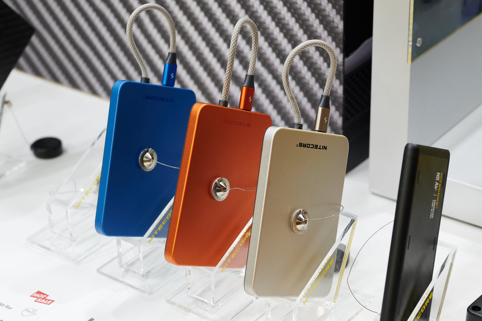 The Nitecore Pocket 5 portable power bank featuring MagSafe and Qi2 compatibility, with a built-in cable that doubles as a carrying strap, available in the UK