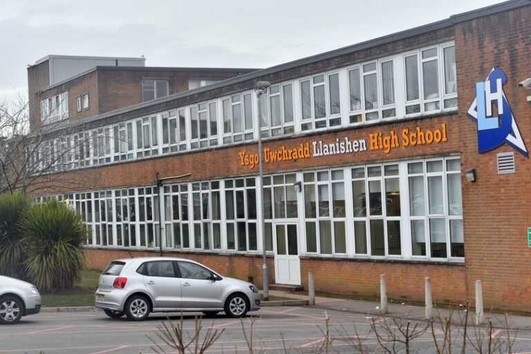 A descriptive image of a Cardiff school building with a police car outside, highlighting the unexpected closure of two schools in the city due to a police investigation, with a focus on student safety and well-being