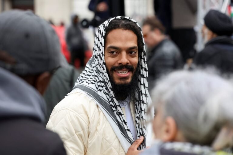 Al Quds rally in London, featuring a large crowd of protesters holding signs and chanting slogans, with a focus on the 'death to IDF' chants led by Bobby Vylan, a prominent figure at the event, highlighting the need for greater awareness and understanding of the potential for hate speech and violence