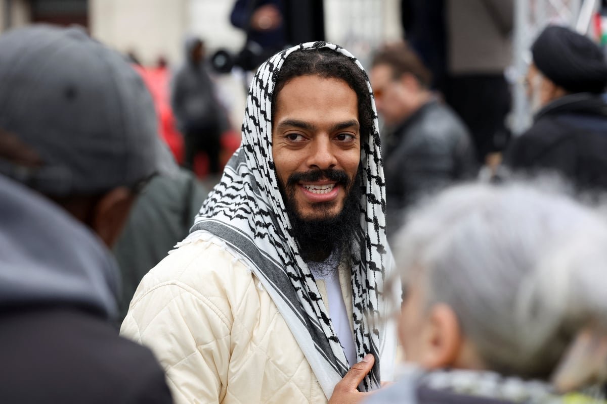 Al Quds rally in London, featuring a large crowd of protesters holding signs and chanting slogans, with a focus on the 'death to IDF' chants led by Bobby Vylan, a prominent figure at the event, highlighting the need for greater awareness and understanding of the potential for hate speech and violence