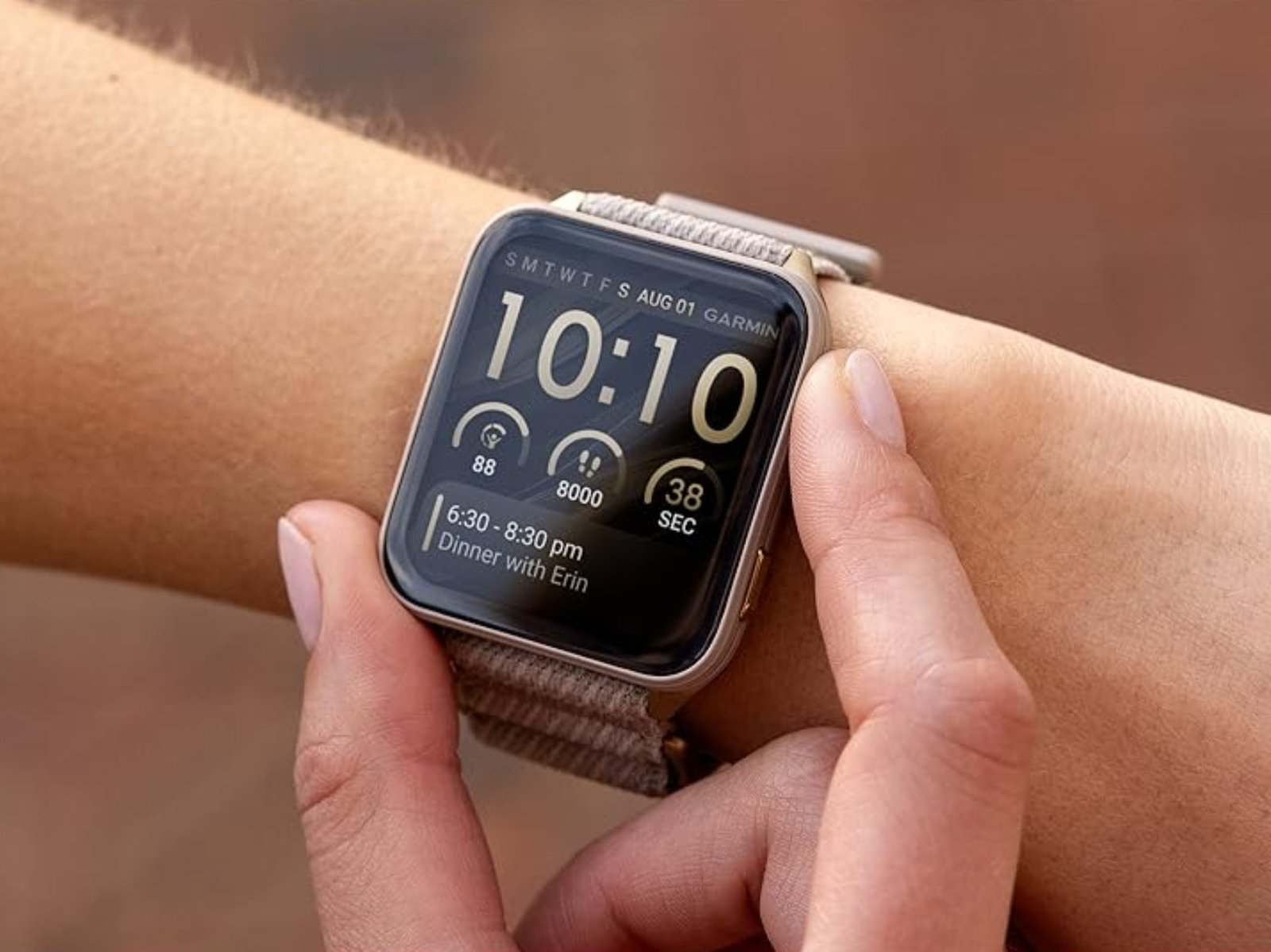 A person wearing a Garmin smartwatch with a new watch face, highlighting the limited rollout and exclusive designs available to certain devices, including the latest models and their vibrant colour schemes