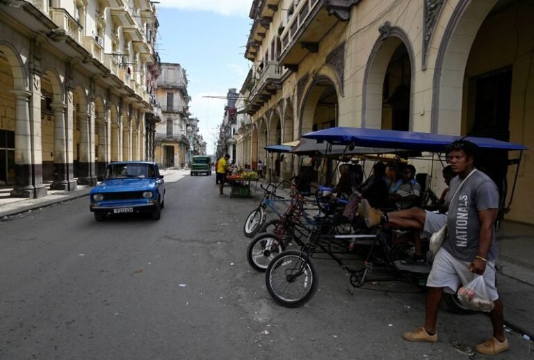 Russian and Cuban flags waving together, symbolising Russia's support for Cuba amidst US hostility, with a subtle colour contrast highlighting the complex nature of international relations