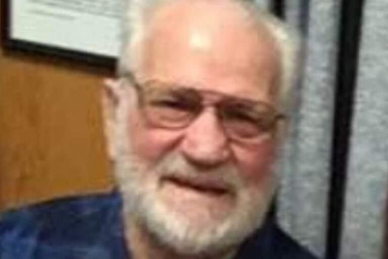 A photo of a car accident scene with a pensioner lying on the road, surrounded by police officers and ambulance crew, highlighting the importance of road safety and the devastating consequences of hit and run accidents
