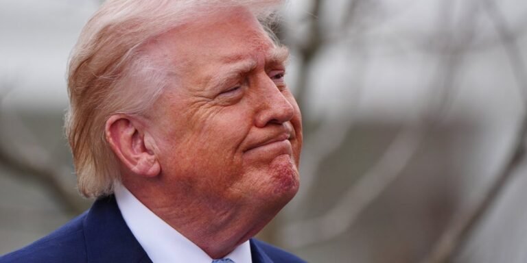 Former UK Security Chief speaking at a press conference, with a serious expression, discussing Trump's Iran strategy and its potential consequences, with a UK and Iran flag in the background, symbolising international relations and diplomacy