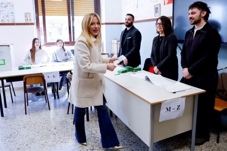 Italian Prime Minister Giorgia Meloni speaking at a press conference, with a solemn expression, as the nation awaits the outcome of the justice referendum, a crucial test of her political reputation and the country's justice system