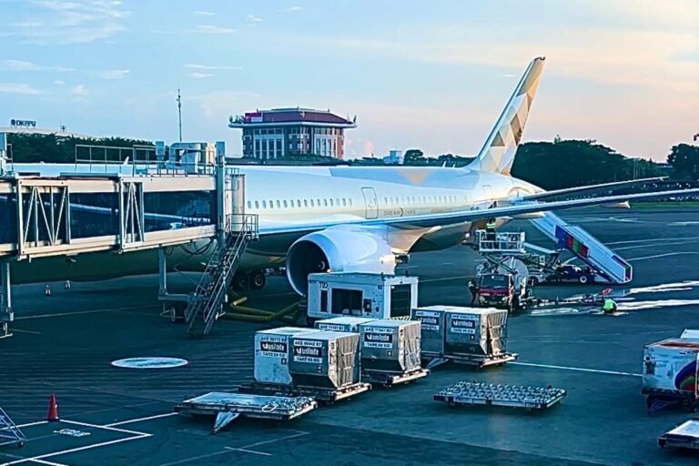 Aerial view of Abu Dhabi's no-go zone, with a plane flying through the restricted area, showcasing the vast expanse of desert and ocean, with the sun casting a warm glow over the landscape, highlighting the beauty of Abu Dhabi