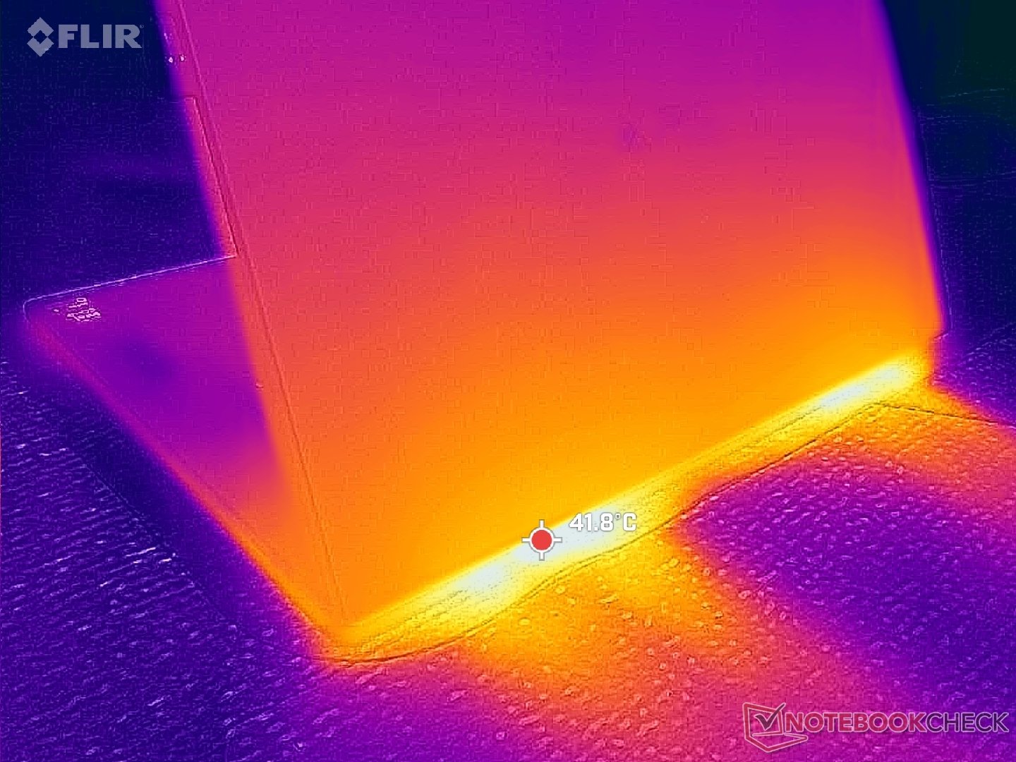 A close-up of the 2026 Dell XPS 16's vents, with a subtle colour gradient to highlight the warmth emanating from the device, showcasing the primary keyword of laptop temperature in a natural setting