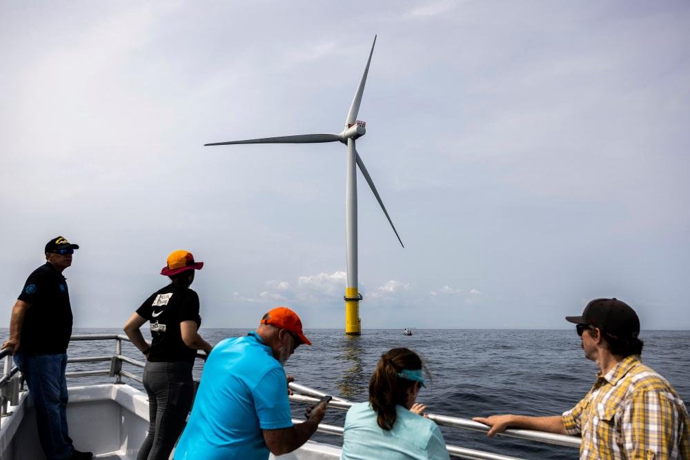 A wind farm in the United States, with wind turbines generating renewable energy, a French energy company has received a payout to kill the wind project plan, amidst concerns over climate change and the US energy policy