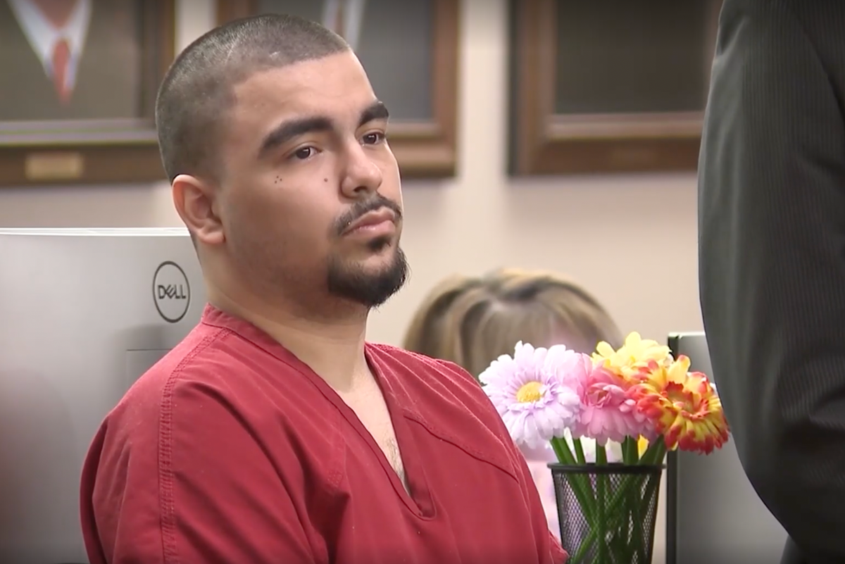 A man in a courtroom, with a judge and lawyers present, sentenced to 50 years for double murder, a tragic crime that has left a community in shock, with a focus on domestic violence and the importance of justice and accountability