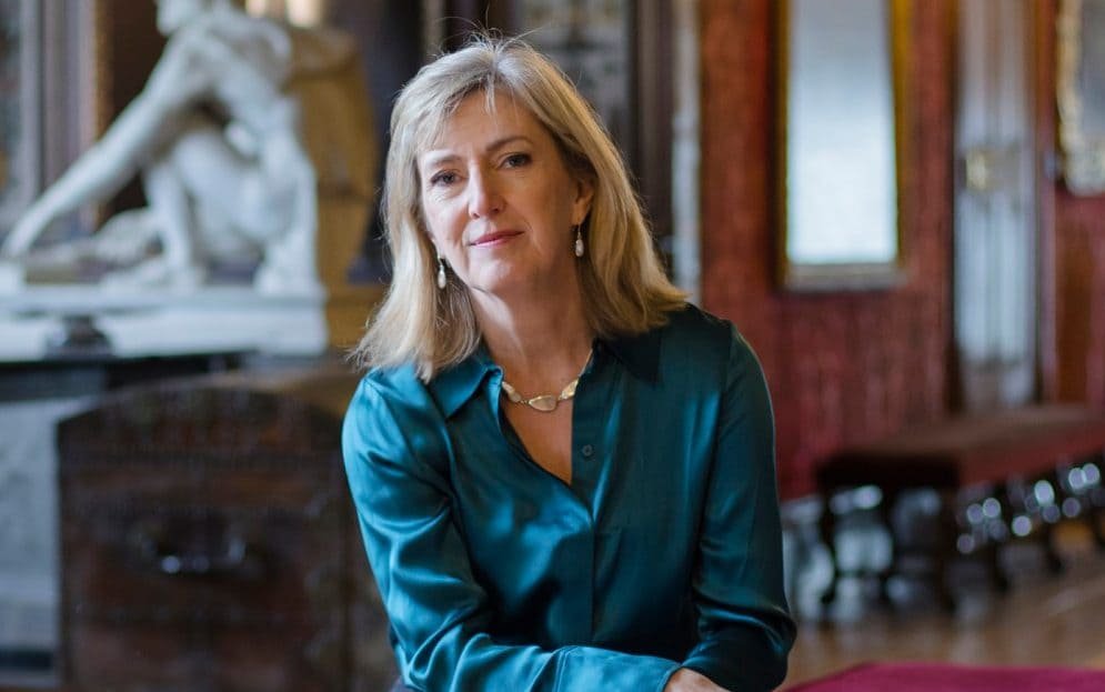 A group of people from different ethnic backgrounds walking in the countryside, enjoying the scenic views and wearing appropriate attire for the occasion, highlighting the importance of inclusive countryside experiences