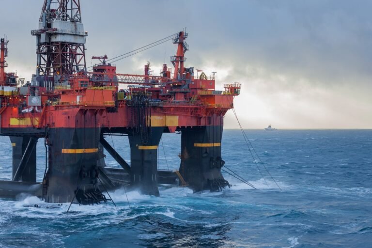 A drilling platform in the North Sea, with a ship nearby, highlighting the importance of North Sea drilling for the UK's energy supplies and security, with a beautiful colour landscape of the sea