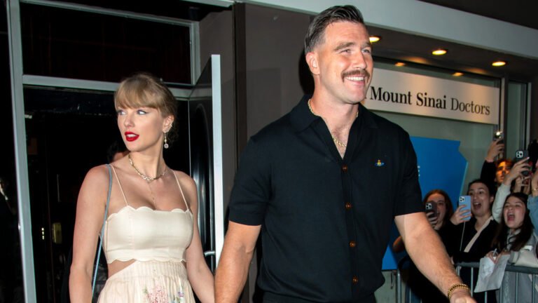 Travis Kelce in action on the football field, posing with his team after signing the £54.7m deal, with a huge smile and a triumphant gesture, surrounded by cheering fans and flashing cameras, showcasing his passion and dedication to the sport, with the stadium's vibrant colour and energetic atmosphere in the background