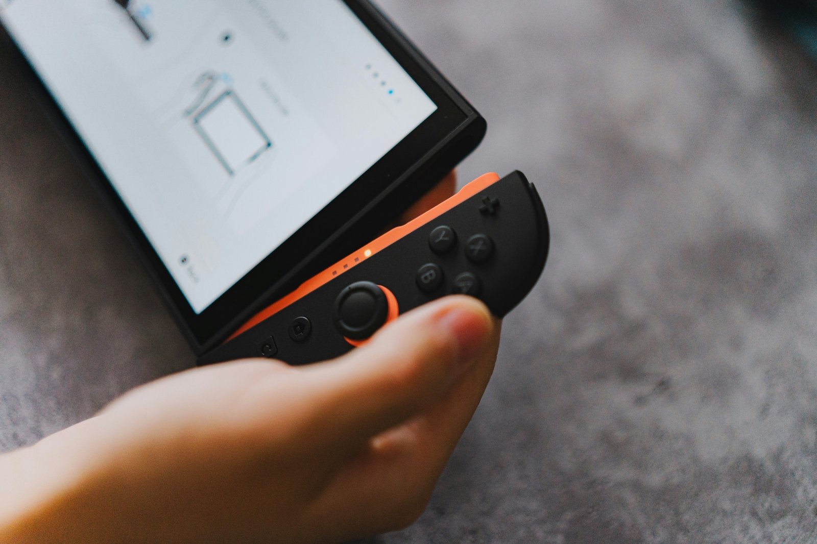 A close-up of a Nintendo Switch 2 cartridge, with a background of UK gamers playing on their consoles, highlighting the difference between physical and digital games