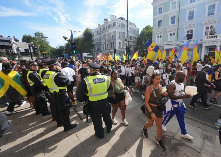 A colourful and vibrant scene from the Notting Hill Carnival, with people dancing and playing music in the streets, showcasing the event's cultural significance and the primary keyword, Notting Hill Carnival