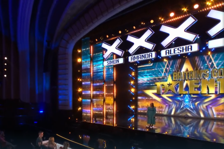 Britain's Got Talent judges in tears during a powerful performance, highlighting the show's emotional impact on its audience and featuring a talented singer on stage with a beautiful colour scheme