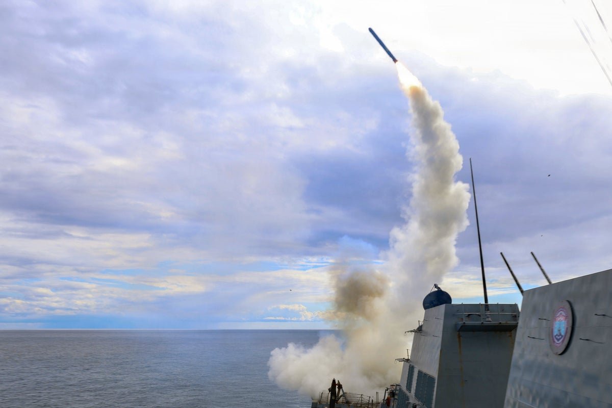 A Tomahawk missile being launched from a US warship, with the primary keyword Tomahawk missiles featured prominently in the image, showcasing the US military's firepower and raising questions about the colour of the situation and the behaviour of the US military