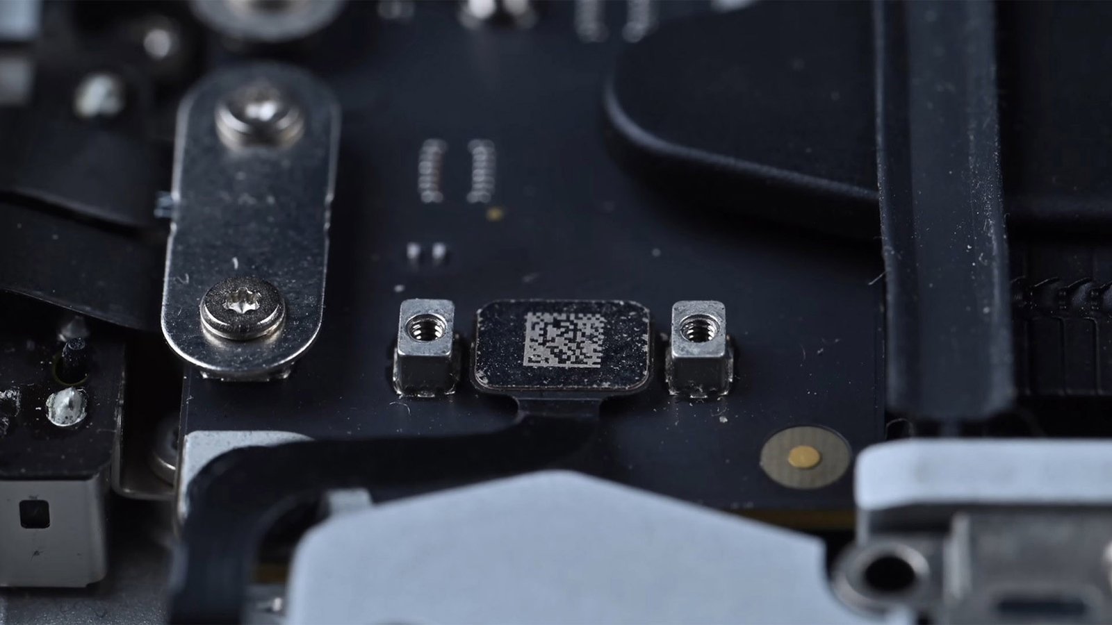 A close-up of a MacBook Pro's Lid Angle Sensor, with a descriptive caption explaining its purpose and function, highlighting the importance of proper diagnosis and repair in the UK