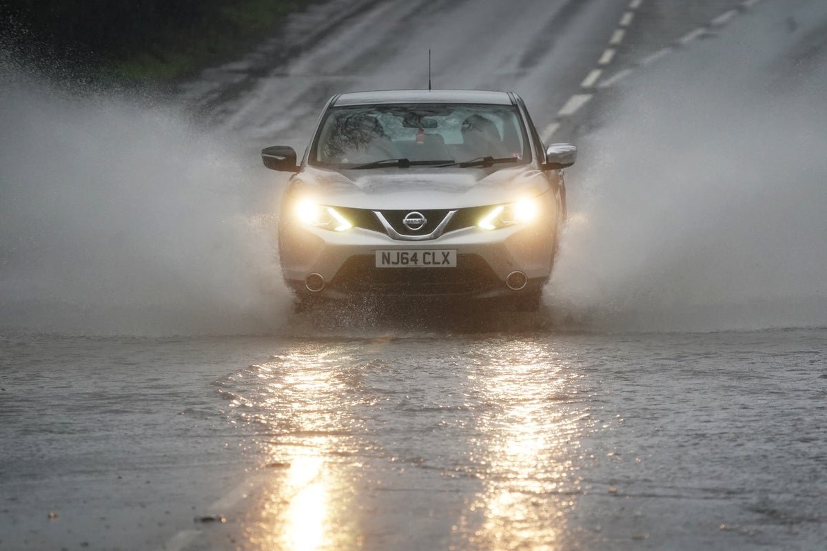 A dramatic UK landscape with dark clouds and hail, giving way to sunnier skies and a rainbow. The image captures the unpredictable nature of the British weather, with the primary keyword 'UK weather' reflected in the scene.