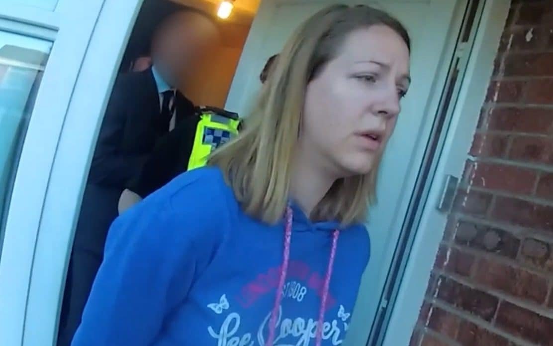 A photograph of a police officer standing outside a station, with a blurred background, representing the Letby police investigation and the need for accountability and transparency, with a focus on the primary keyword phrase 'Letby police investigation'
