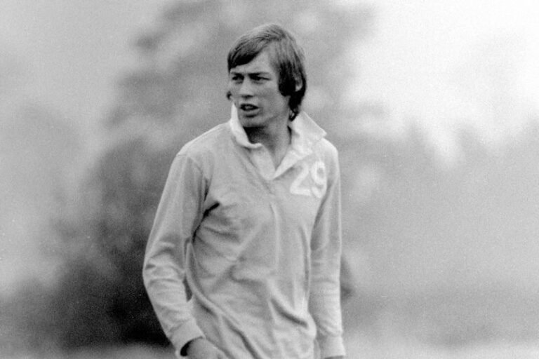 A photo of the Hibs legend in action on the pitch, surrounded by fans and fellow players, with a colourful backdrop of the Edinburgh stadium, highlighting the individual's impressive skills and dedication to the sport, as the primary keyword, Hibs legend, is honoured