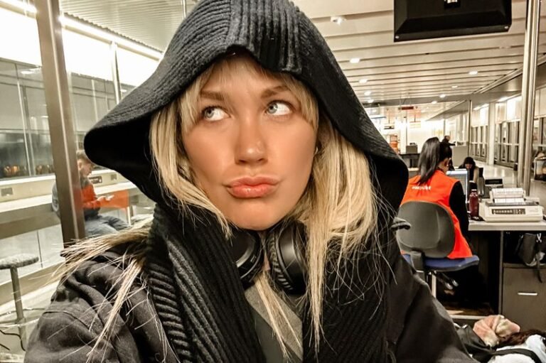 A passenger's passport being checked at Birmingham Airport, highlighting the importance of Ryanair's 10-year passport rule for air travel