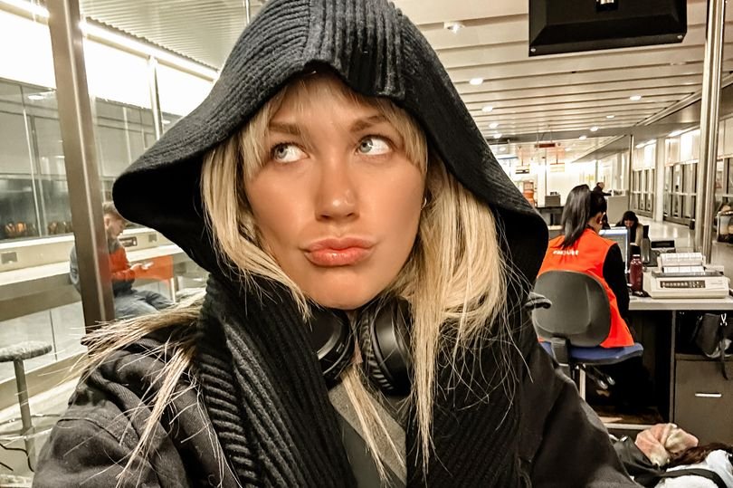 A passenger's passport being checked at Birmingham Airport, highlighting the importance of Ryanair's 10-year passport rule for air travel