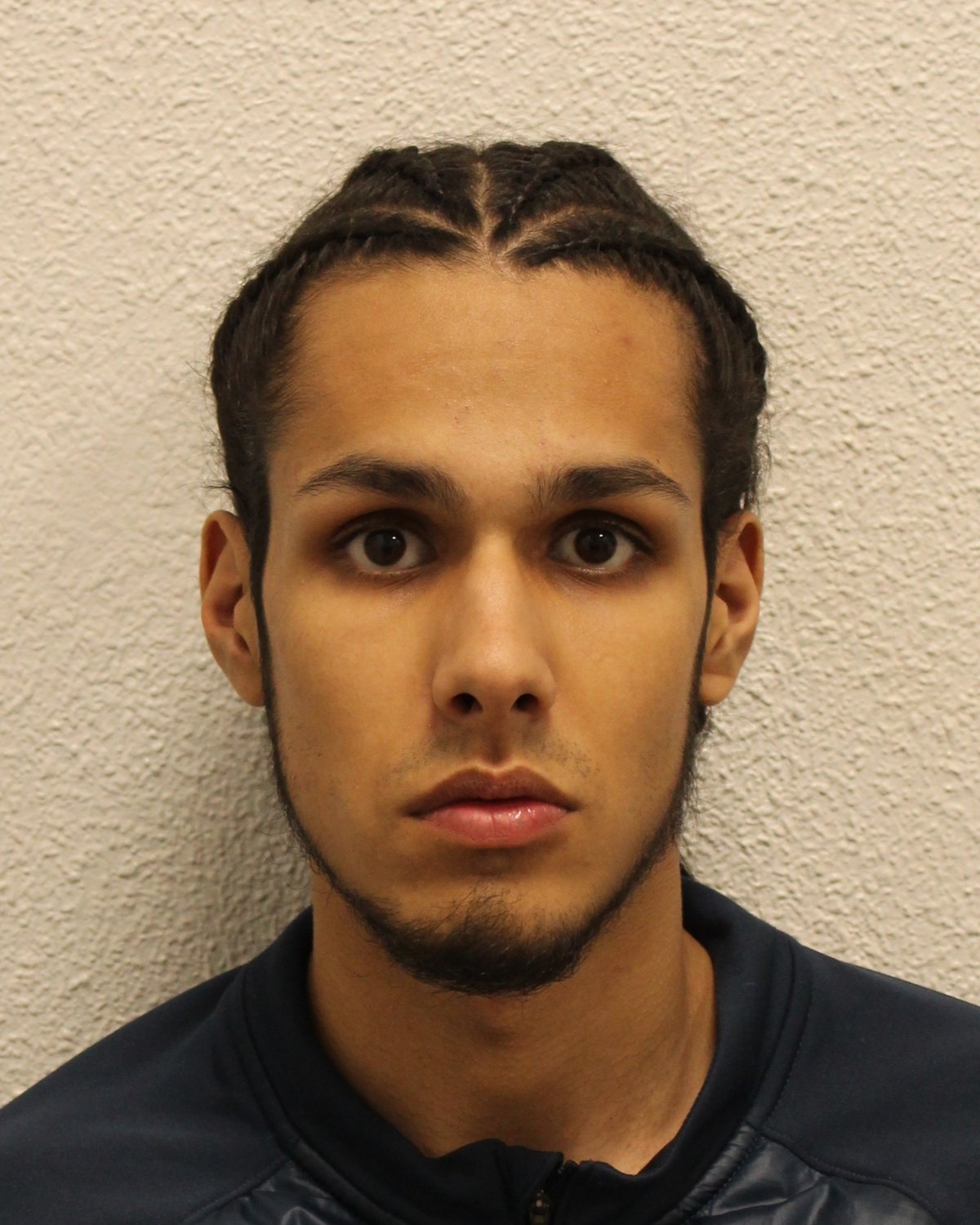 A man in a courtroom, handcuffed and surrounded by police officers, with a caption reading 'Justice served: man convicted of fatal Thornton Heath stabbing'