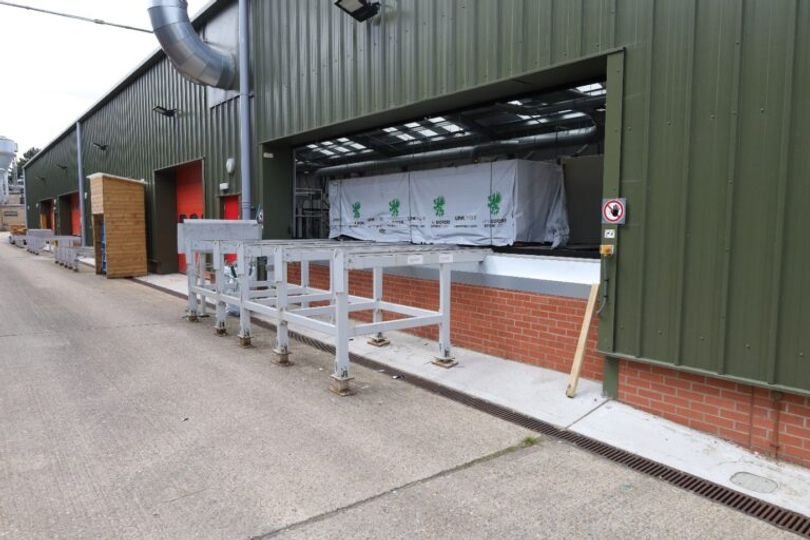 A conveyor belt with a warning sign in the background, highlighting the importance of workplace safety and the devastating consequences of accidents, with a focus on the primary keyword phrase workplace safety