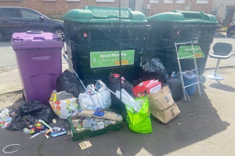 A pile of rubbish and debris on a street in Edinburgh, with a sign in the background reading 'No Fly Tipping'