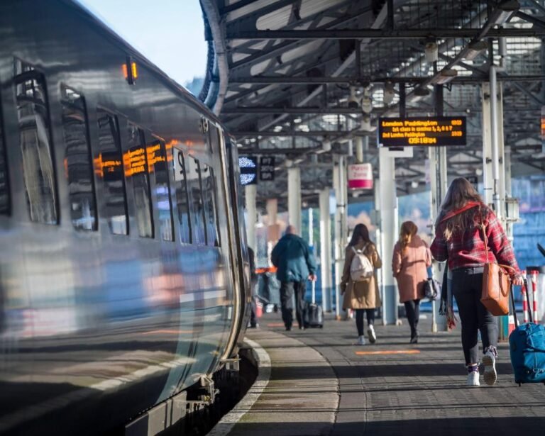 Young people from the EU and UK participating in a cultural exchange programme, with a banner reading 'Youth Mobility Scheme' in the background