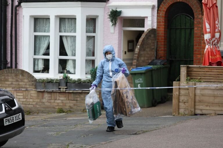 A forensic tent outside a southeast London home where an elderly woman was stabbed to death, with police officers and forensic teams investigating the crime scene, highlighting the importance of community safety and the need to analyse the behaviour of perpetrators