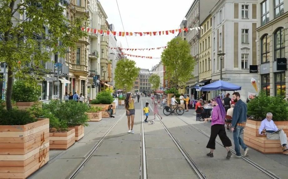 Berlin's city centre, with cars and buses, as the city proposes a car ban to reduce traffic congestion and improve air quality, with a focus on a sustainable future