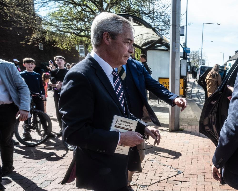 A group of diverse people discussing and analysing local election candidates, with a focus on community engagement and effective governance, highlighting the importance of local democracy