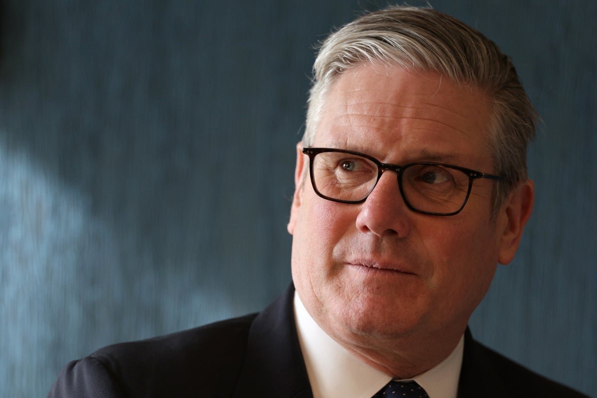 A descriptive image of a person holding a sign that reads 'Stop Benefit Cuts', with a blurred background of people protesting, highlighting the primary keyword 'benefits cuts' and the impact on vulnerable citizens